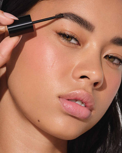 Applying Shade Dark Brown: Volumizing Tinted Brow Gel