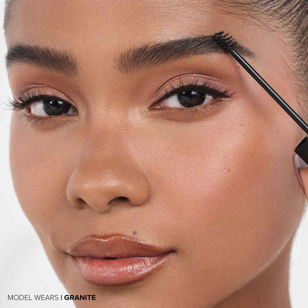Granite | Volumizing Tinted Brow Gel -Model Holding Product Wand